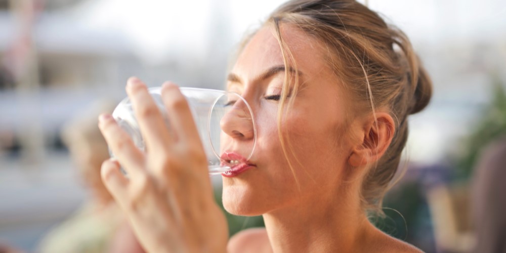 woman drinking a glass of water