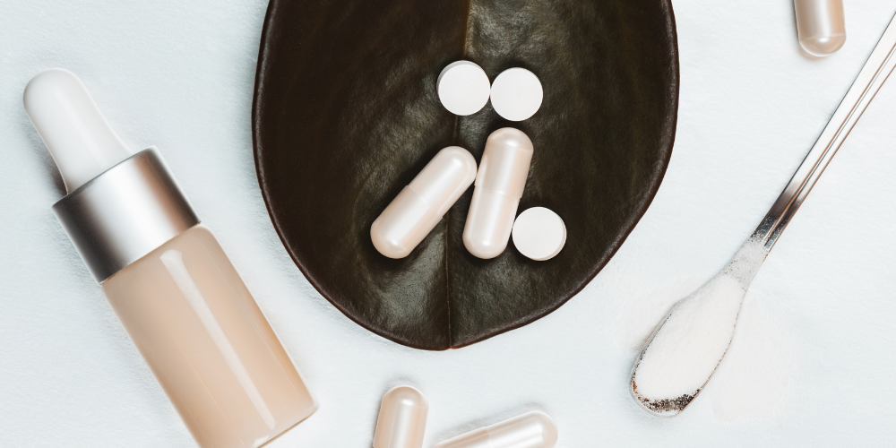 Supplements and powder displayed with a dropper bottle.